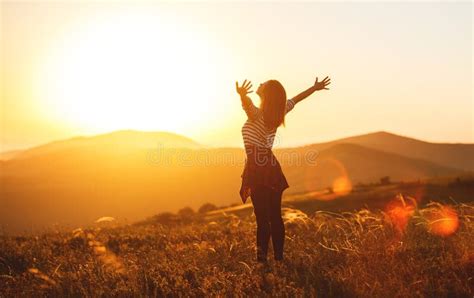 Happy Woman Jumping And Enjoying Life At Sunset In Mountains Stock