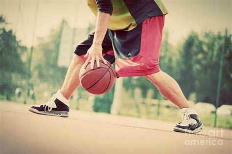 Young Man On Basketball Court Dribbling With Ball Photograph By Michal