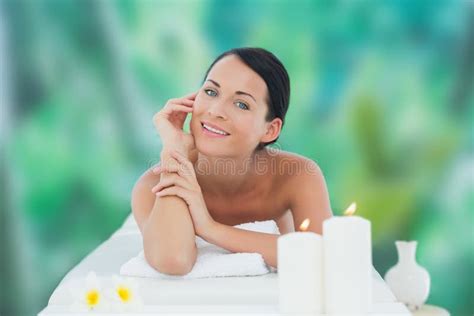 Beautiful Brunette Relaxing On Massage Table Smiling At Camera Stock Image Image Of Calm