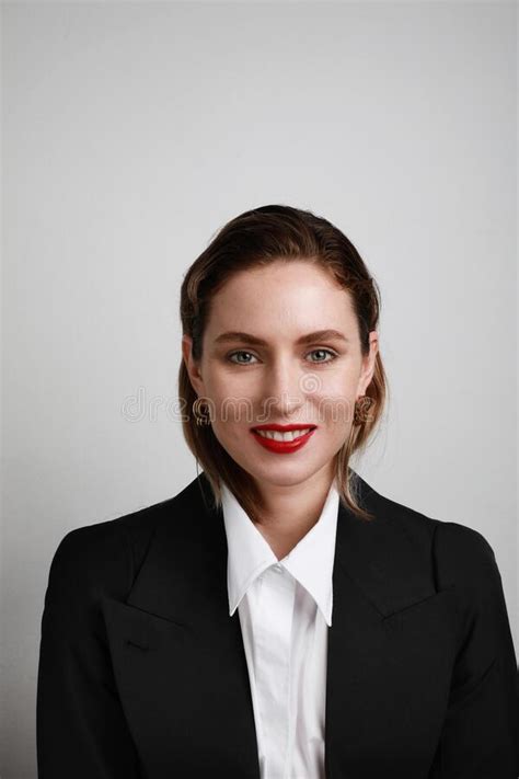 Portrait Of Business Young Woman Posing Over White Wall Confident