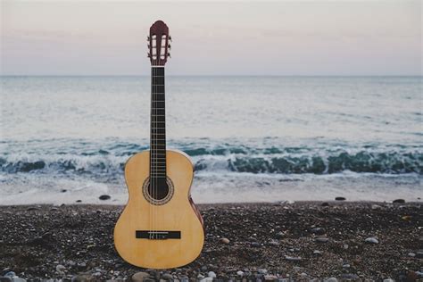 Premium Photo Classical Guitar In The Beach With Sea Views