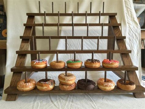 There Are Many Donuts On The Wooden Stand