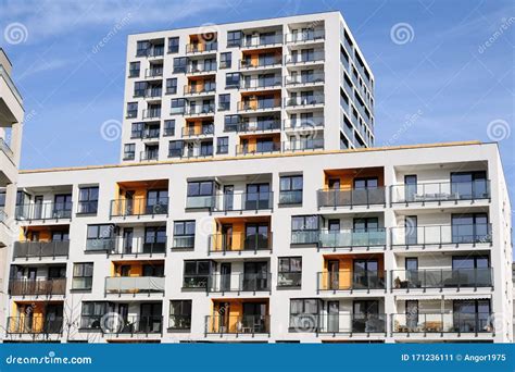 Facades Of Two Modern White Apartment Buildings With Balcony In