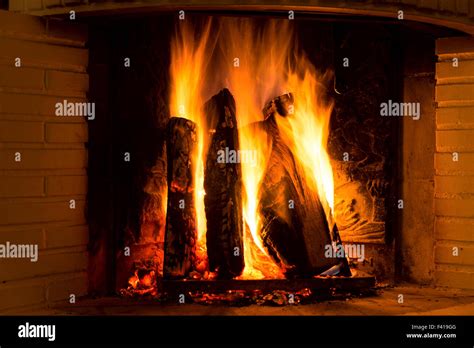 Burning Fireplace With Vertical Firewood Stock Photo Alamy