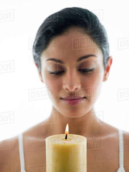 Close Up Of Woman Admiring Candle Stock Photo Dissolve