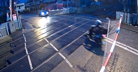 Reckless Moped Riders Smash Into Level Crossing Barriers Before