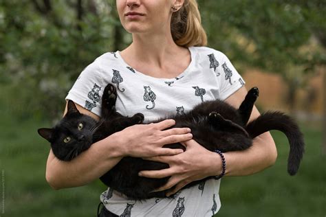 woman holding her black cat by stocksy contributor ibex media stocksy