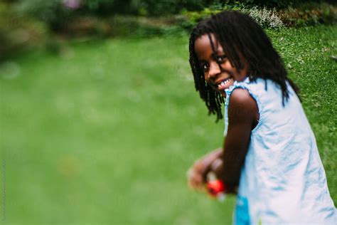 African American Girl Smiling Outdoors By Stocksy Contributor Gabi