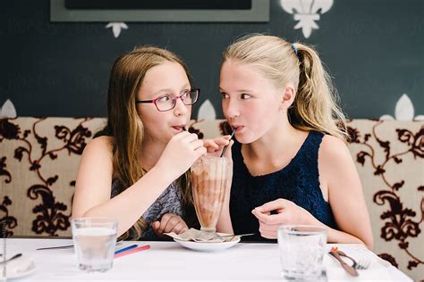 Teen Girls Sharing A Milkshake Del Colaborador De Stocksy Gillian