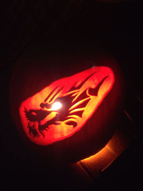 A Carved Pumpkin With A Dragon On It