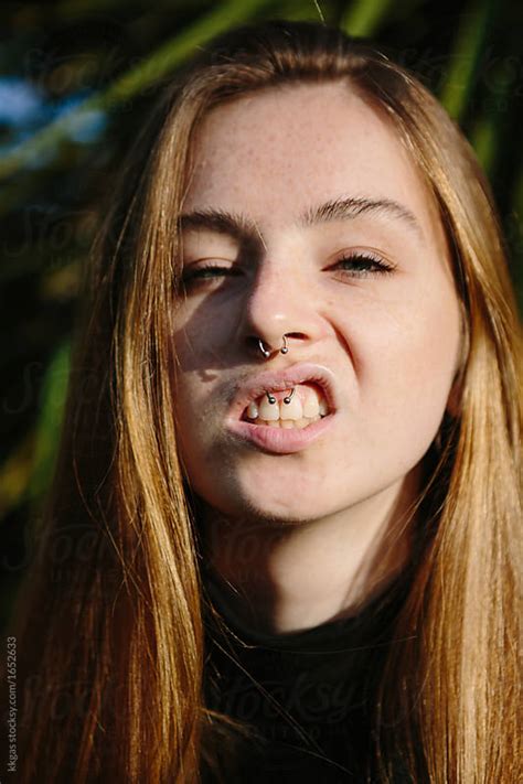 Pretty Young Woman With Freckles Showing Her Septum And
