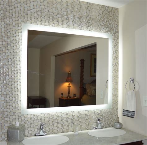 A Bathroom With Two Sinks And A Large Mirror In Its Center Along With A Lamp On The Wall