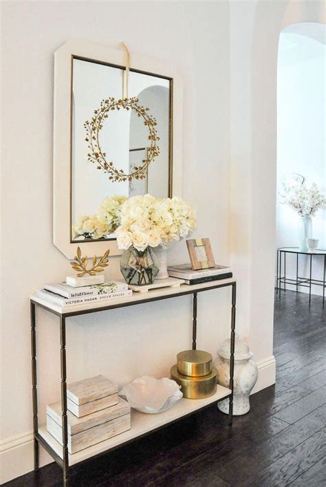 Useful and elegant, console tables are more than just a place to throw your mail. White console table #entry #entrydecor #consoletable #entryway #entryhall #interiorstyling #H ...