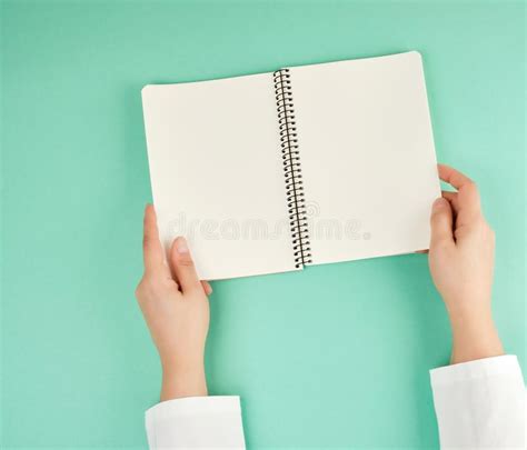 Two Female Hands Holding Open Notepad With Clean Sheets Stock Image