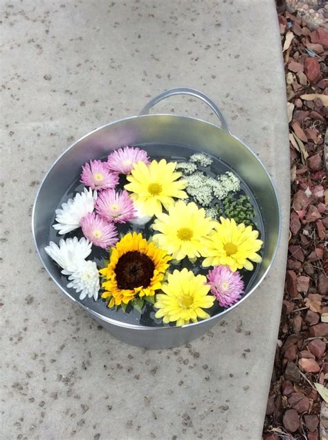 I've been planning on getting some cute buckets to replace the wicker baskets on the bookcase in my kiddos' room. Added floating flowers to dollar store plastic buckets ...