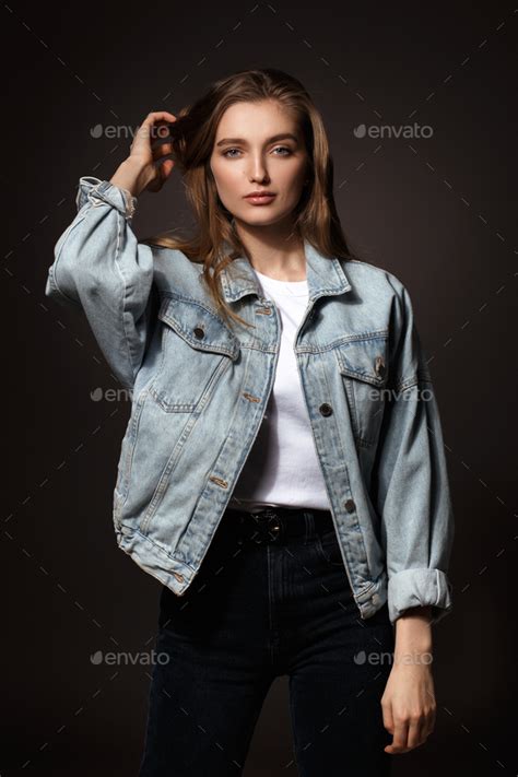 Gorgeous Brunette Girl With Long Flowing Hair Dressed In Jeans Jacket
