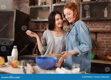 Positive Delighted Lesbians While Cooking Stock Image Image Of Milk