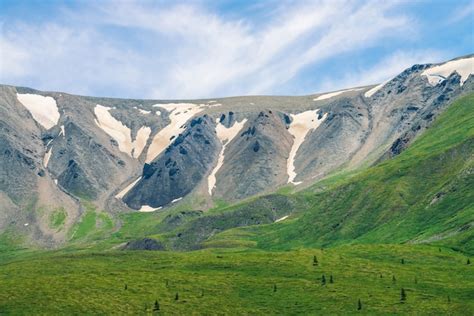 Premium Photo Giant Gray Rocky Mountainside With Dirty Snow Above