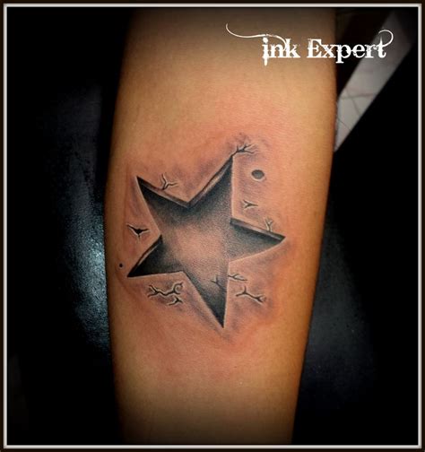 A Black And White Photo Of A Star Tattoo On The Arm With Words Ink Expert