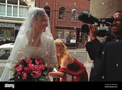 Bride Arrives At Church Greeted By Her Bridesmaids And Pageboys And