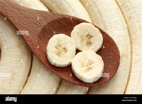 Bananas In A Wooden Spoon On Bananas Background Closeup Stock Photo