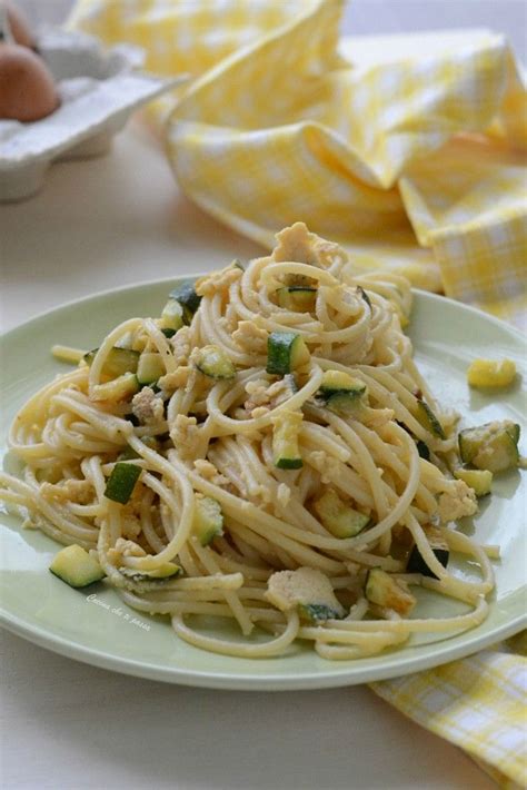 A White Plate Topped With Pasta And Veggies On Top Of A Yellow