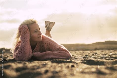 Beautiful Model Lay Down On The Sand At The Beach Enjoying Relax Golden