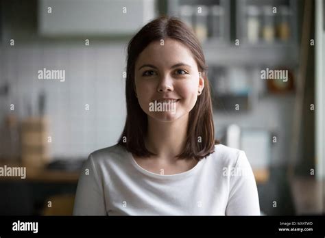 Headshot Portrait Of Smiling Millennial Woman Posing At Home Kit Stock