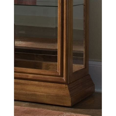 Curios can be added to any room as an accent piece or a way to display collectibles. Pulaski 2 Way Sliding Door Curio Cabinet in Golden Oak - 20544