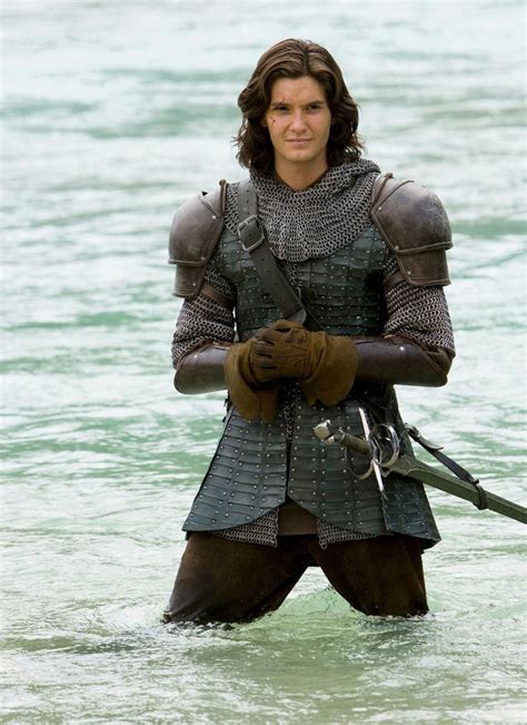 A Man Standing In The Water Wearing Armor