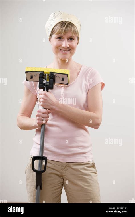Smiling Woman Holding Mop Stock Photo Alamy