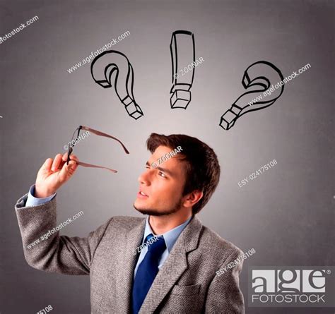Young Man Thinking With Question Marks Overhead Stock Photo Picture