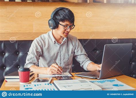 Asian Man Using Laptop Computer Working On His New Project