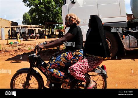 Burkinabe Women Riding A Motorcycle In Ouagadougou Burkina Faso Stock