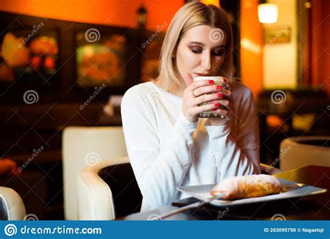 Beautiful Woman Drinking Coffee At The Cafe Wintertime Stock Photo