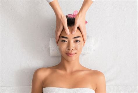 Young Asian Woman Enjoying Anti Aging Facial Massage At Spa Salon Stock Image Image Of Facial