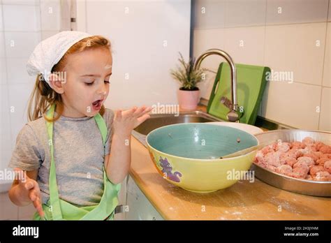 Girl Sucking Her Finger While Cooking Meat Balls With Flour In Her