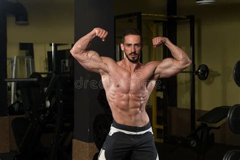 Bodybuilder Performing Rear Double Biceps Pose Stock Image Image Of Indoors Athlete