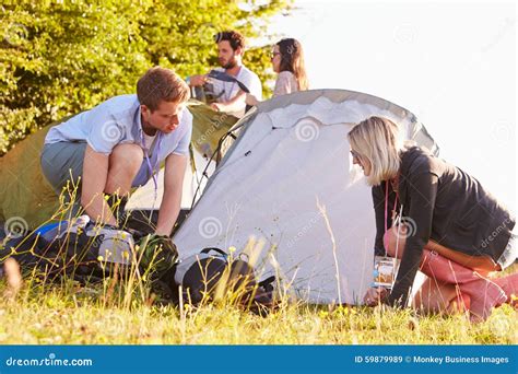 Group Of Young Friends Pitching Tents On Camping Holiday Stock Image