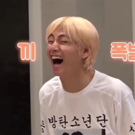 A Man With Blonde Hair Laughing And Wearing A White T Shirt