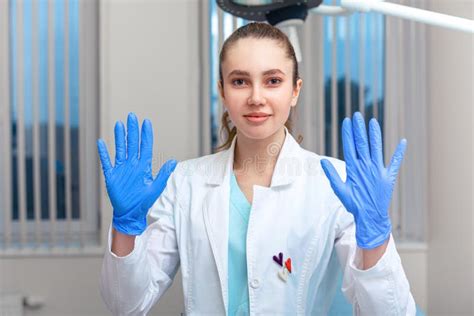 Doctor S Hands Putting On Latex Gloves In A Hospital Woman In A Doctor