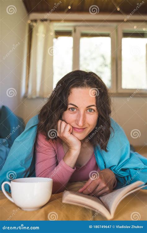 Smiling Girl Reads A Book And Drinks Coffee While Lying In Bed Stock Image Image Of Cosy