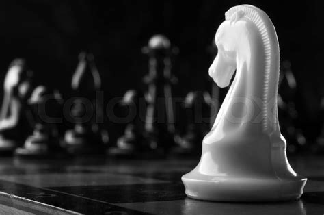 White Knight Chess Piece On The Board Background Stock Image Colourbox