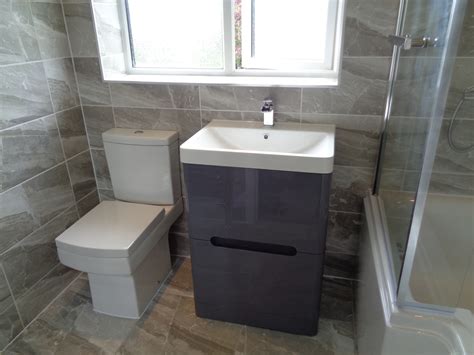 The slate tiles are highlighted with floor level led lighting that acts as a safety marker along the edge of a step. Refitting Bathroom in Stratford Upon Avon with Grey Theme