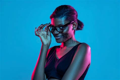 Portrait Of Young Beautiful Dark Skinned Woman Posing Isolated On Blue
