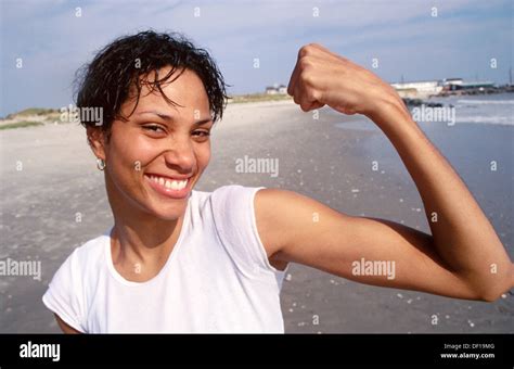 Young Woman Flexing Muscles Stock Photo Alamy
