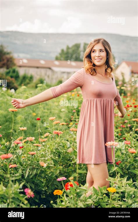 Outdoor Portrait Of Young Beautiful Woman In Summer Garden Arms Wide