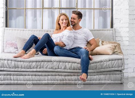 Young Couple Cuddling On The Sofa Stock Photo Image Of Cozy Passion