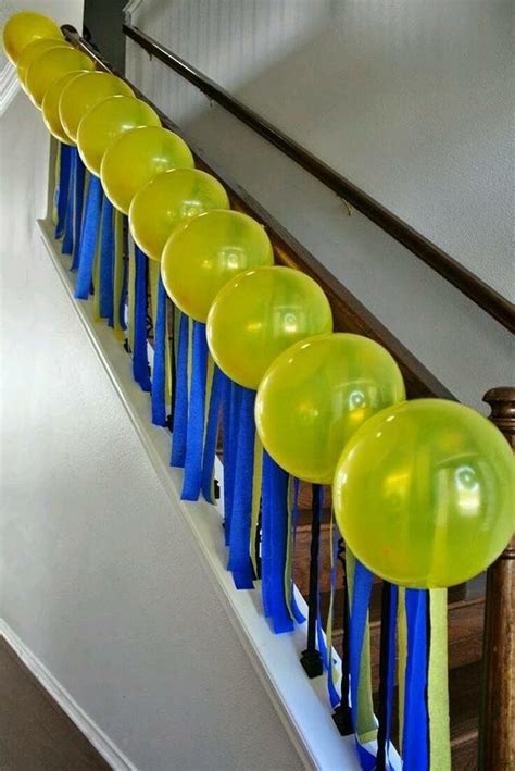 Yellow And Blue Balloons Are Lined Up On The Banisters At The Bottom Of
