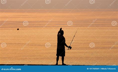 Man Fishing Alone In The Sea At Sunrise Or Sunset Editorial Stock Image